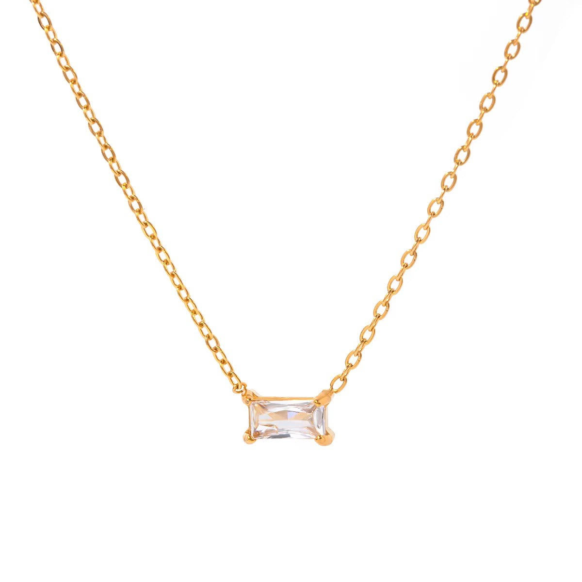 Gold necklace with a rectangular clear gemstone on a white background
