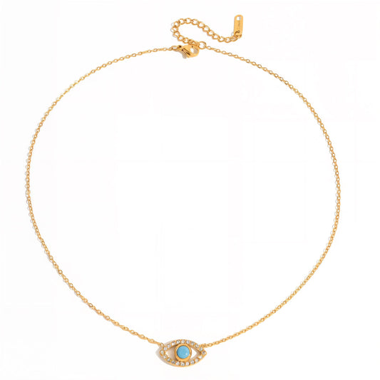 Gold necklace with a blue gemstone pendant on a white background